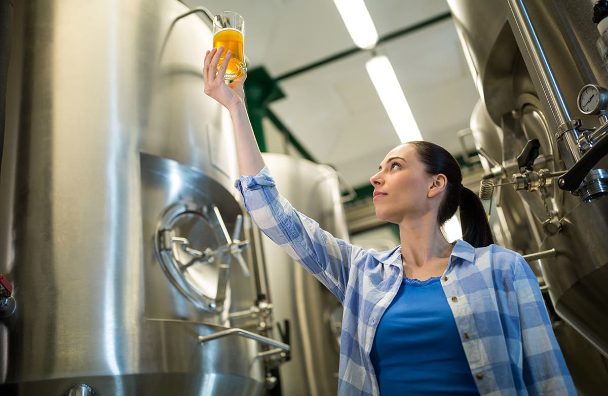 Woman brewing beer in a brewery